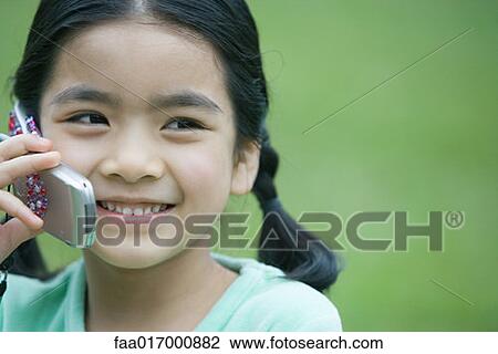 Little girl using cell phone, close-up View Large Photo Image Stock Image - Little girl using cell phone, close-up. Fotosearch