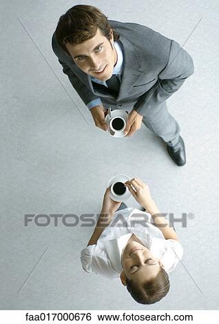 Male and female associates having coffee, full length, high angle view View Large Photo Image Stock Photograph - Male and female associates having coffee, full length, high angle view. Fotosearch