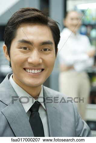 Male executive in break room, smiling at camera, portrait View Large Photo Image Stock Photo - Male executive in break room, smiling at camera, portrait. Fotosearch