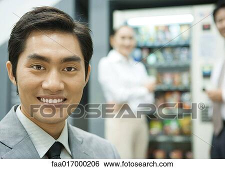 Male executive in break room, smiling at camera, portrait View Large Photo Image Stock Photograph - Male executive in break room, smiling at camera, portrait. Fotosearch