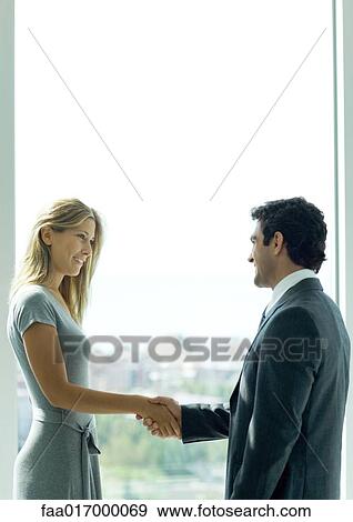 Stock Photo - Man and woman shaking hands. Fotosearch
