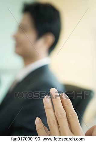 Man's hands, businessman in blurred background View Large Photo Image Stock Image - Man's hands, businessman in blurred background. Fotosearch