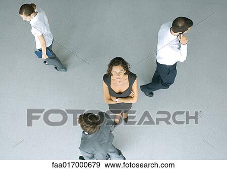 Mature businesswoman standing with arms folded and eyes closed, colleagues passing by, high angle view View Large Photo Image Stock Photo - Mature businesswoman standing with arms folded and eyes closed, colleagues passing by, high angle view. Fotosearch