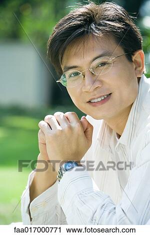 Mid adult man wearing glasses, portrait View Large Photo Image Stock Image - Mid adult man wearing glasses, portrait. Fotosearch
