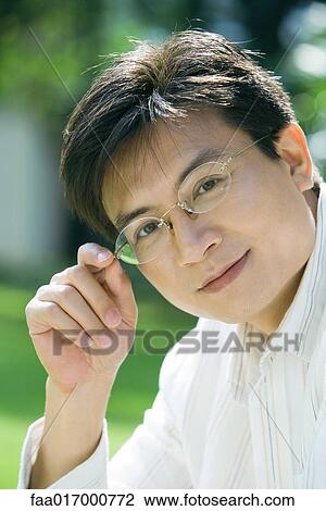 Mid adult man wearing glasses, portrait View Large Photo Image Stock Image - Mid adult man wearing glasses, portrait. Fotosearch