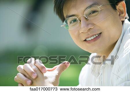 Mid adult man wearing glasses, portrait View Large Photo Image Stock Image - Mid adult man wearing glasses, portrait. Fotosearch