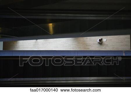 Stock Image - Office building interior, person in distance. Fotosearch