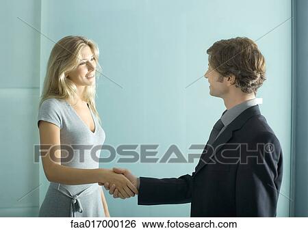 Stock Photograph - Professional man and woman shaking hands. Fotosearch
