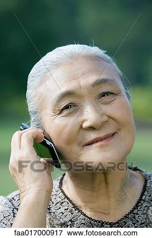 Stock Photo - Senior woman using cell phone. Fotosearch