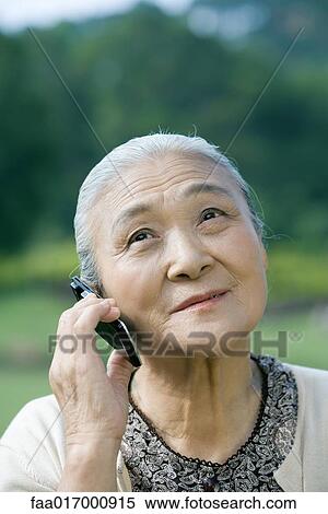 Stock Photography - Senior woman using cell phone. Fotosearch