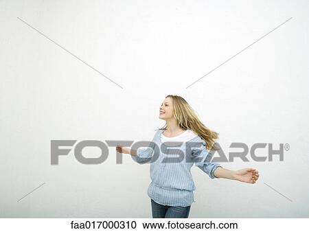 Stock Image - Teenage girl dancing, portrait. Fotosearch