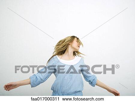 Stock Image - Teenage girl dancing, portrait. Fotosearch
