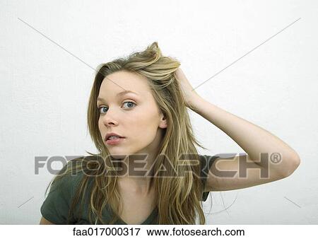 Teenage girl pushing hair back and looking at camera, portrait View Large Photo Image Stock Photo - Teenage girl pushing hair back and looking at camera, portrait. Fotosearch