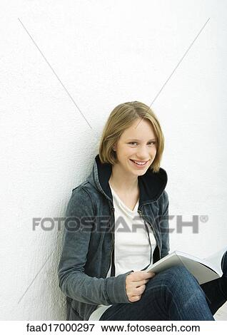 Stock Photo - Teenage girl reading, portrait. Fotosearch