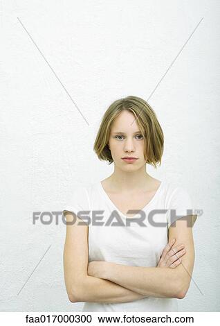 Teenage girl standing with arms crossed, portrait View Large Photo Image Stock Image - Teenage girl standing with arms crossed, portrait. Fotosearch