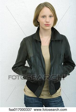 Teenage girl standing with hands in pockets, portrait View Large Photo Image Stock Photo - Teenage girl standing with hands in pockets, portrait. Fotosearch