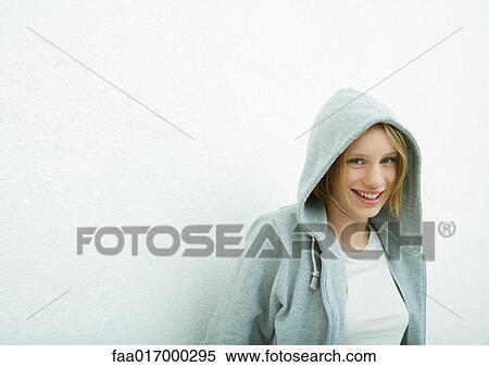 Stock Photography - Teenage girl wearing hood, portrait. Fotosearch