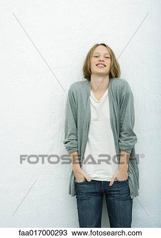 Stock Image - Teenage girl with hands in pockets, portrait. Fotosearch