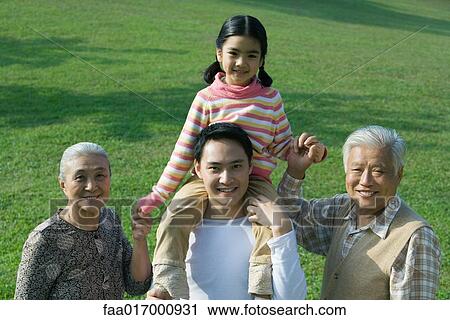 Three generation family, girl sitting on father's shoulders, holding grandparent's hands, portrait View Large Photo Image Stock Image - Three generation family, girl sitting on father's shoulders, holding grandparent's hands, portrait. Fotosearch