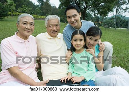 Three generation family, smiling at camera View Large Photo Image Stock Image - Three generation family, smiling at camera. Fotosearch