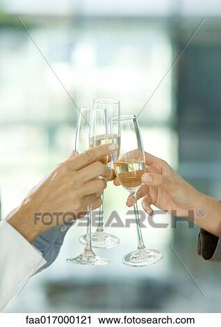 Toasting with glasses of champagne, cropped view of hands View Large Photo Image Stock Image - Toasting with glasses of champagne, cropped view of hands. Fotosearch
