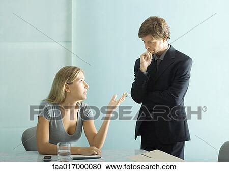 Stock Image - Two business colleagues having conversation. Fotosearch