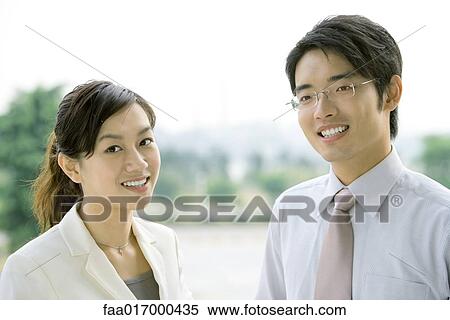 Two business executives, smiling at camera, head and shoulders, portrait View Large Photo Image Stock Photography - Two business executives, smiling at camera, head and shoulders, portrait. Fotosearch