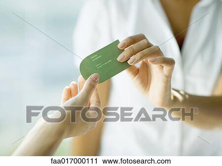 Woman handing second woman business card, close-up of hands View Large Photo Image Stock Image - Woman handing second woman business card, close-up of hands. Fotosearch