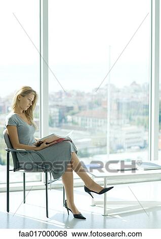 Stock Photo - Woman sitting in waiting room. Fotosearch