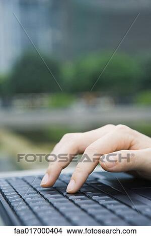 Woman typing on laptop keyboard, close-up of hand View Large Photo Image Picture - Woman typing on laptop keyboard, close-up of hand. Fotosearch
