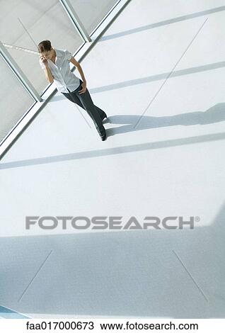 Woman using cell phone, full length, high angle view View Large Photo Image Stock Image - Woman using cell phone, full length, high angle view. Fotosearch