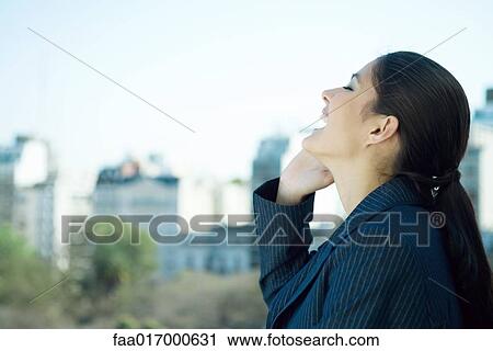 Woman using cell phone, laughing, side view View Large Photo Image Stock Image - Woman using cell phone, laughing, side view. Fotosearch