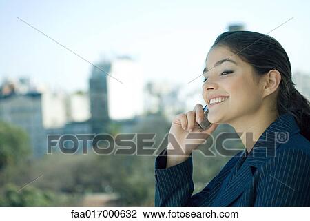 Woman using cell phone, side view View Large Photo Image Stock Image - Woman using cell phone, side view. Fotosearch