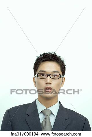 Picture - Young businessman with mouth open, staring at camera, portrait. Fotosearch