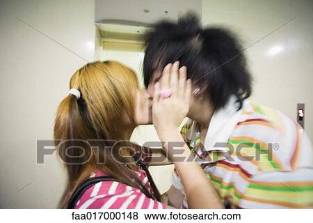 Stock Photo - Young couple kissing. Fotosearch