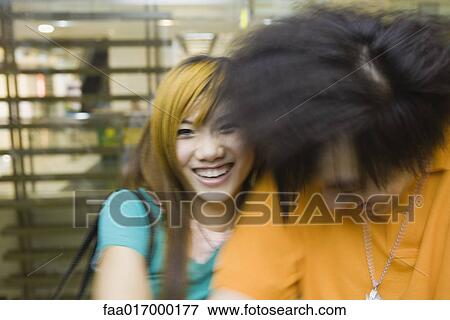 Young couple laughing, blurred motion View Large Photo Image Stock Photo - Young couple laughing, blurred motion. Fotosearch