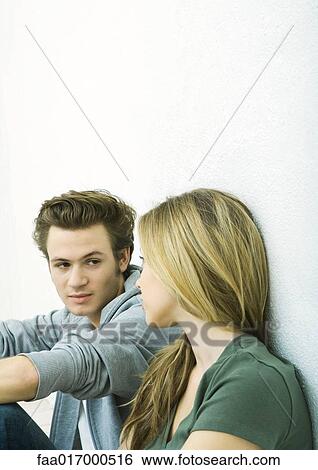 Stock Photograph - Young couple looking at each other. Fotosearch
