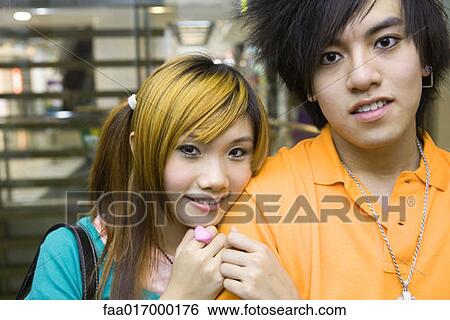 Stock Photograph - Young couple, portrait, looking at camera. Fotosearch