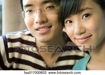 Young couple, smiling at camera, portrait View Large Photo Image Stock Image - Young couple, smiling at camera, portrait. Fotosearch