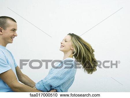 Young couple spinning around, white background View Large Photo Image Stock Image - Young couple spinning around, white background. Fotosearch