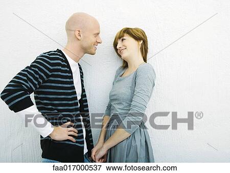 Stock Photo - Young couple talking, side view. Fotosearch