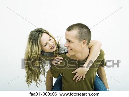 Young couple, teenage girl on young man's back, white background View Large Photo Image Stock Photograph - Young couple, teenage girl on young man's back, white background. Fotosearch
