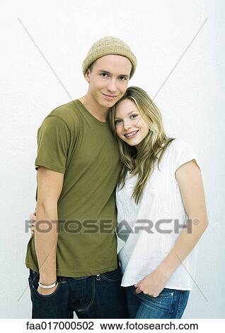 Stock Image - Young couple, teenage girl resting head on young man's shoulder. Fotosearch