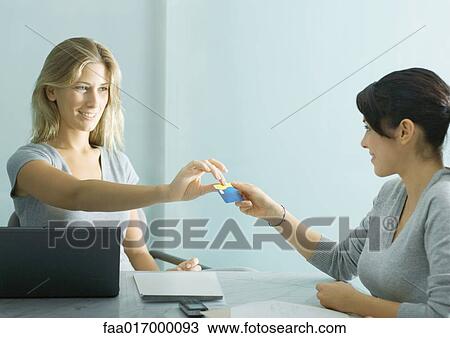 Young female professional handing teenage girl a card View Large Photo Image Stock Image - Young female professional handing teenage girl a card. Fotosearch