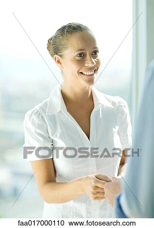 Stock Image - Young female professional smiling. Fotosearch