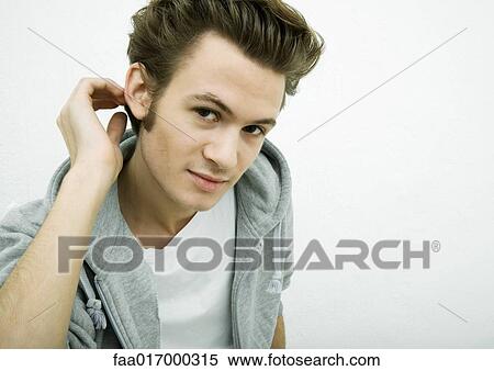 Young man leaning toward camera, portrait View Large Photo Image Stock Photography - Young man leaning toward camera, portrait. Fotosearch