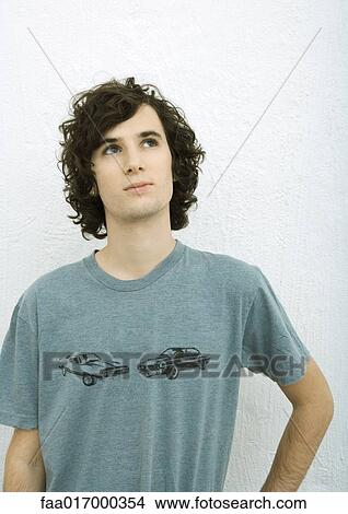 Young man looking up, portrait, white background View Large Photo Image Picture - Young man looking up, portrait, white background. Fotosearch