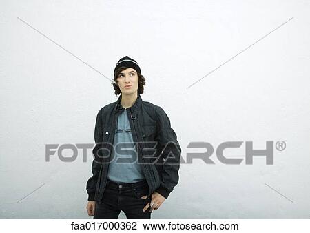 Young man wearing knit hat and jacket, looking up View Large Photo Image Stock Image - Young man wearing knit hat and jacket, looking up. Fotosearch