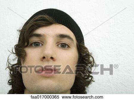 Young man wearing knit hat, close-up of face, portrait View Large Photo Image Stock Photography - Young man wearing knit hat, close-up of face, portrait. Fotosearch