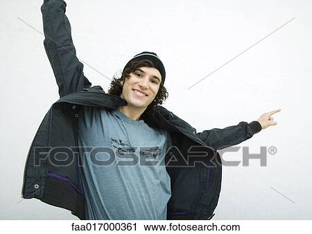 Young man with arms out, smiling at camera, portrait View Large Photo Image Stock Image - Young man with arms out, smiling at camera, portrait. Fotosearch